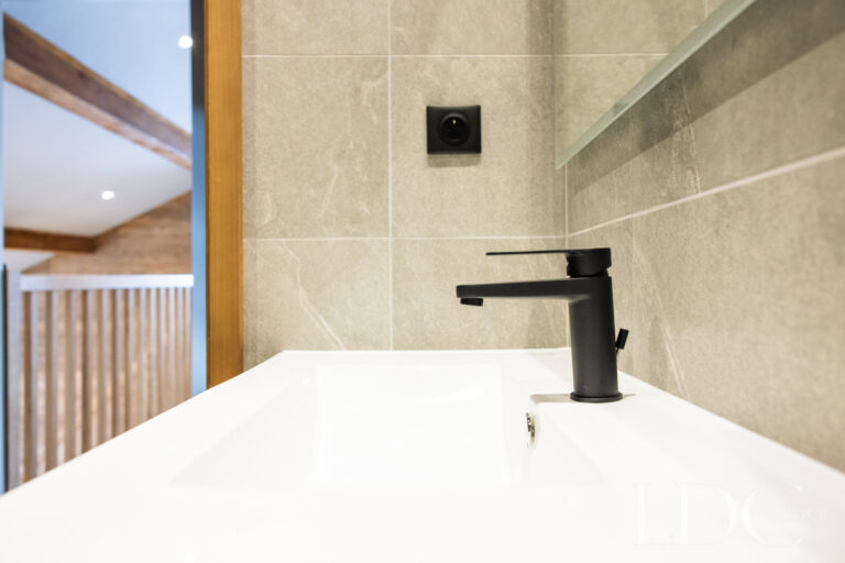 Contemporary bathroom basin with black fittings at La Florette
