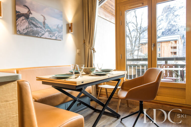 Dining area beside the balcony with mountain views at La Florette in St Martin de Belleville