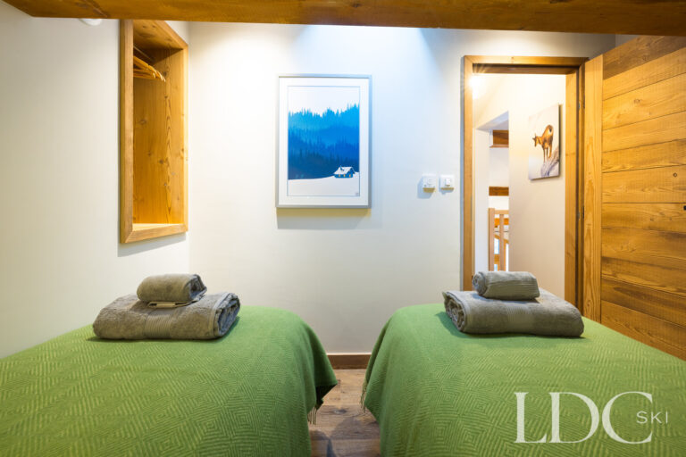 Green bedroom arranged with twin beds at La Florette
