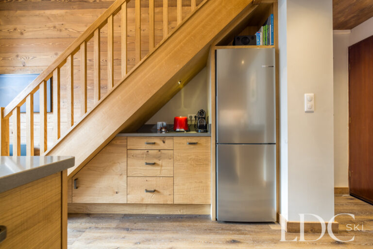 Kitchen with wooden cabinetry beneath the staircase at La Florette