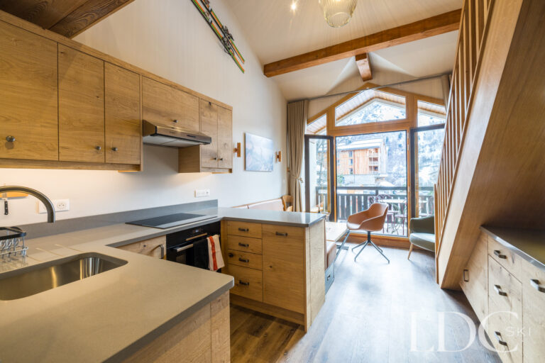 Kitchen leading towards the balcony and mountain views at La Florette