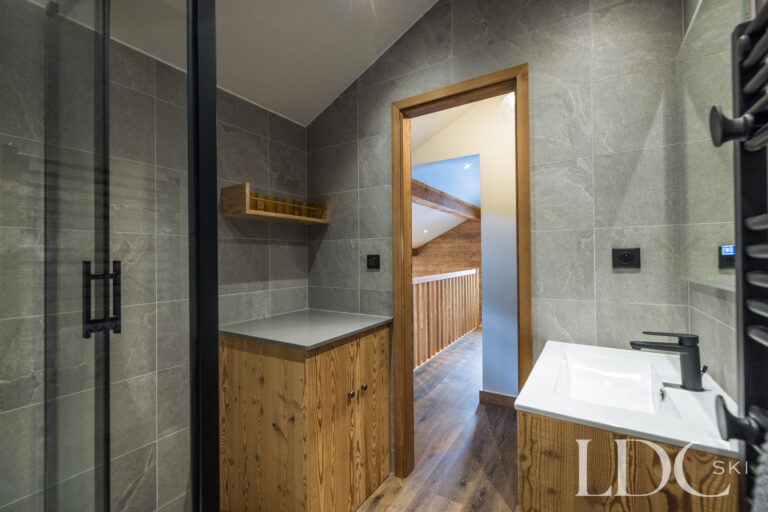 Modern shower room with walk-in shower and timber vanity at La Florette