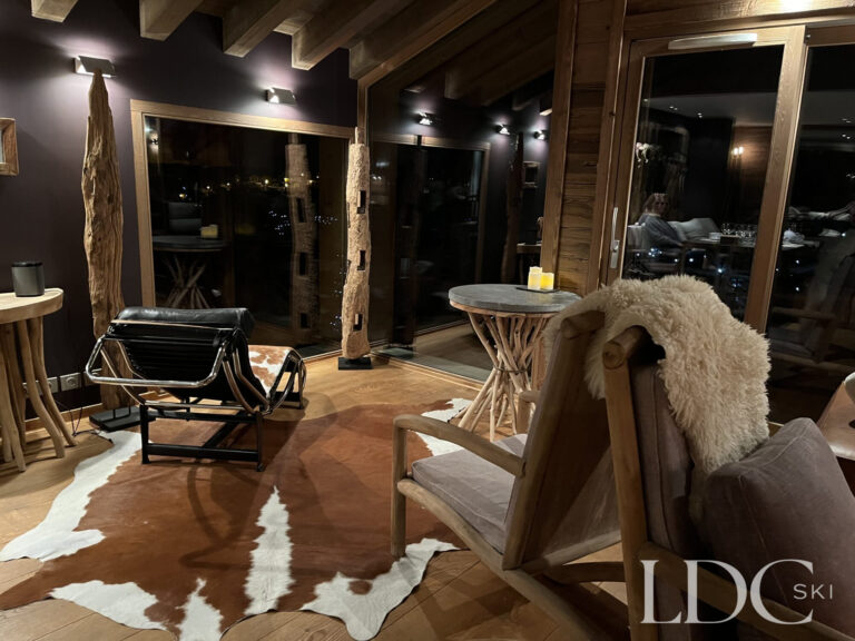 Stylish bar and seating area with traditional timber detailing at Le Chalet