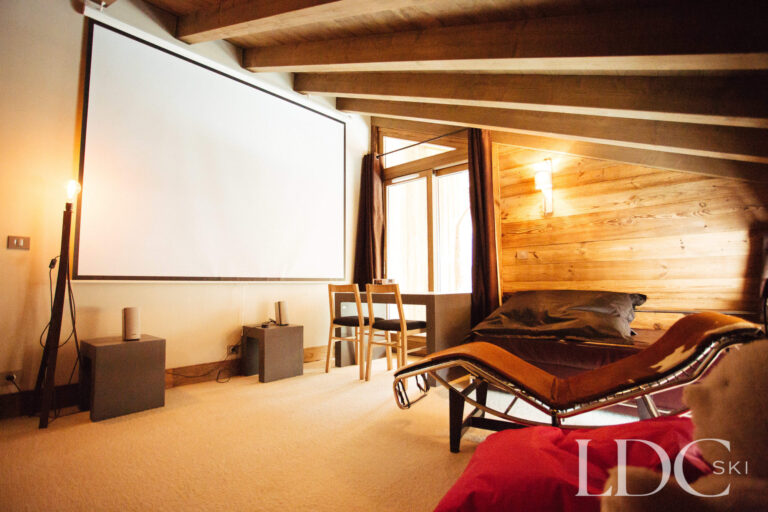 Private cinema room with large screen and comfortable seating at Le Chalet