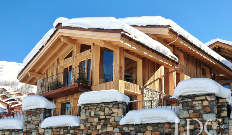 Close exterior view of the stone and timber façade of Le Chalet in St Martin de Belleville