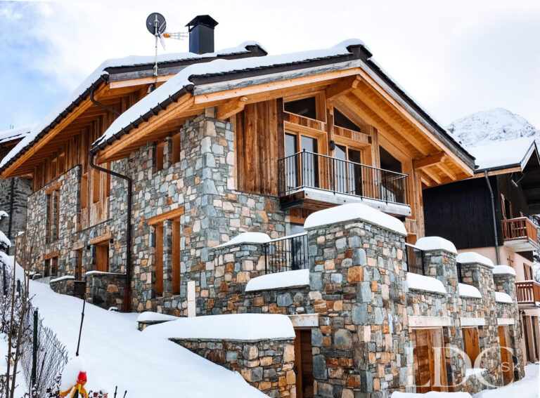 Snow-covered stone and timber exterior of Le Chalet in St Martin de Belleville