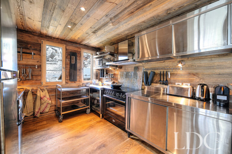 Traditional timber kitchen with professional-style cooking facilities at Le Chalet