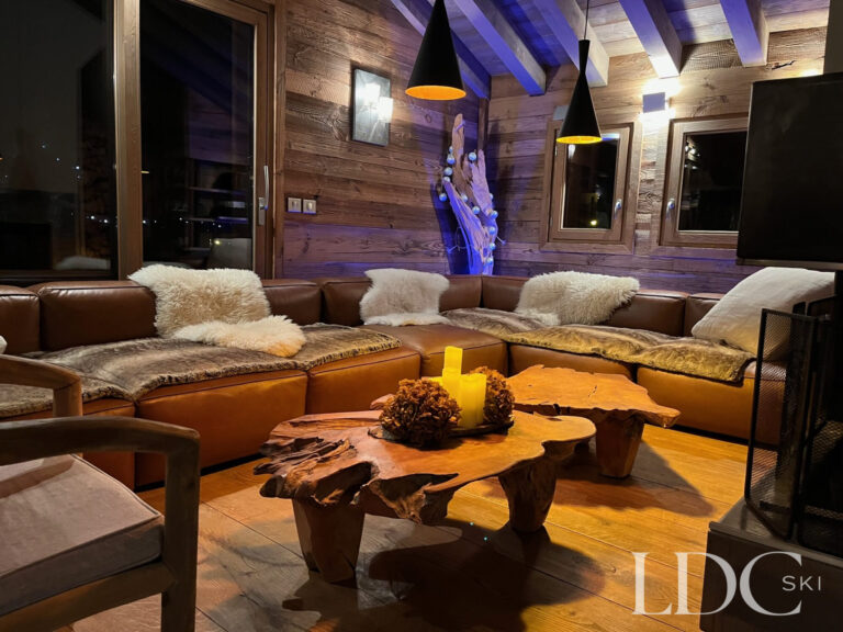 Warm and inviting lounge with timber interiors at Le Chalet in St Martin de Belleville