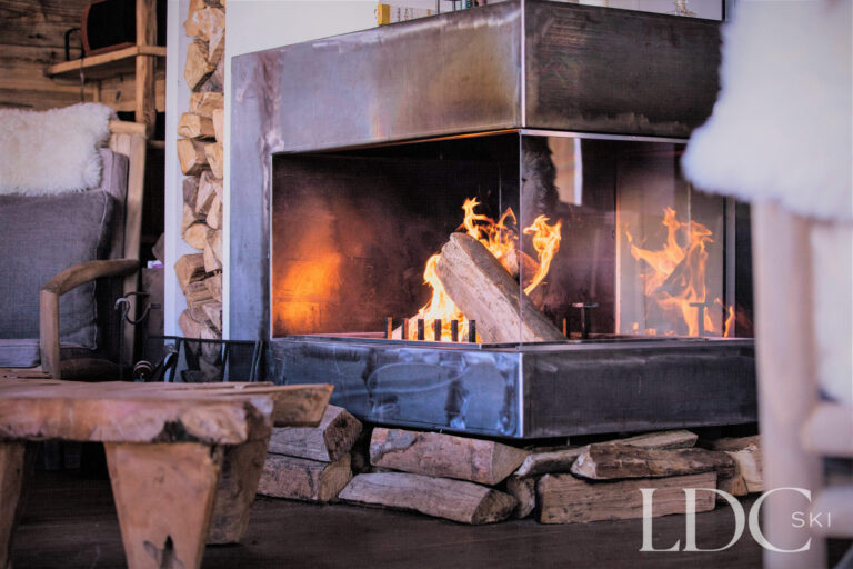 Roaring open fire creating a cosy atmosphere at Le Chalet