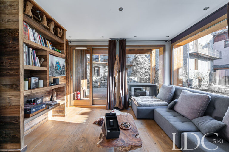Comfortable reading area with large windows and snowy views at Le Chalet