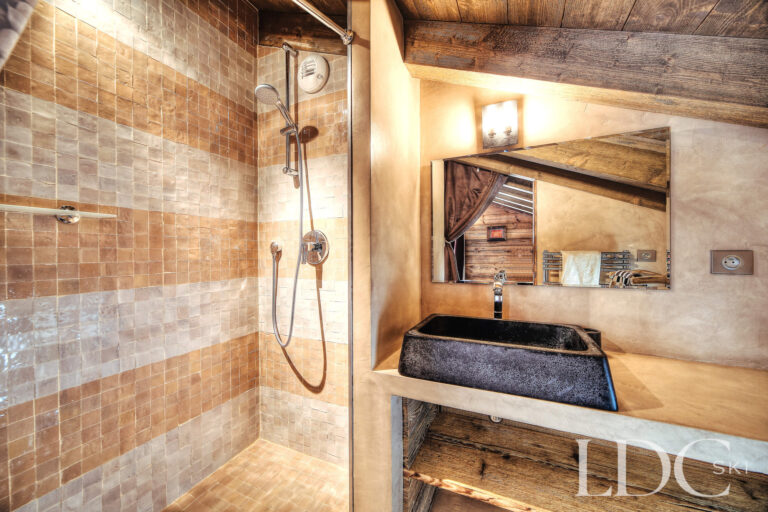 Walk-in shower and stone basin in a shower room at Le Chalet