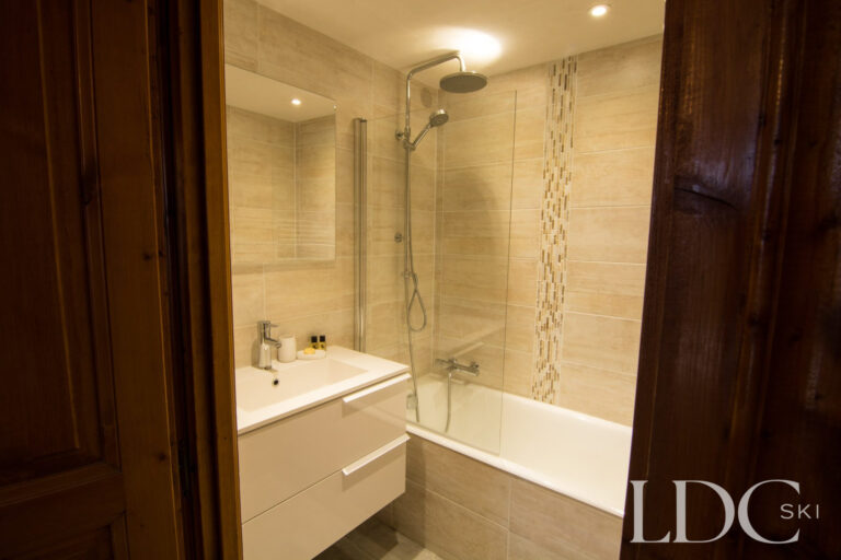 Modern bathroom with bath and overhead shower at Marguerite