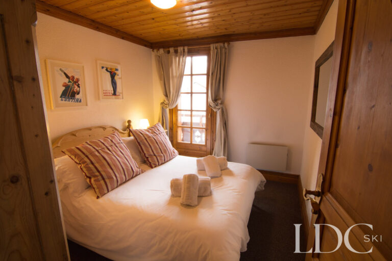 Double bedroom with balcony doors at Marguerite in St Martin de Belleville