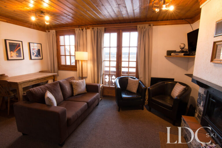 Traditional Alpine-style lounge with comfortable seating and fireplace at Marguerite