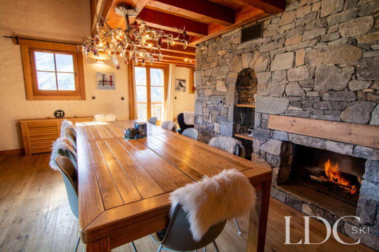 Dining area beside the large stone fireplace at Nant Giraud