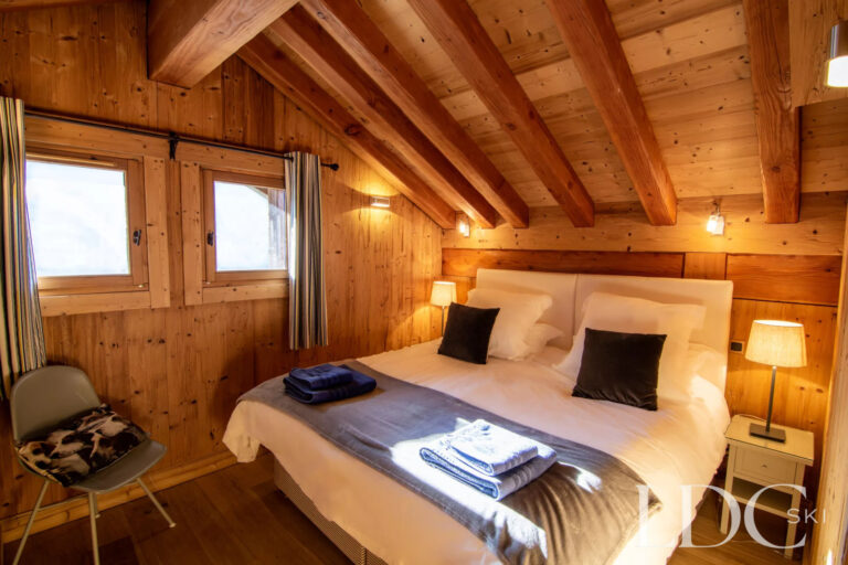 Warm wood-panelled double bedroom at Nant Giraud