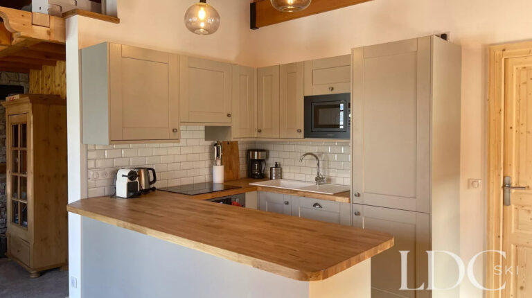 Modern open-plan kitchen with timber worktops at Perce Neige