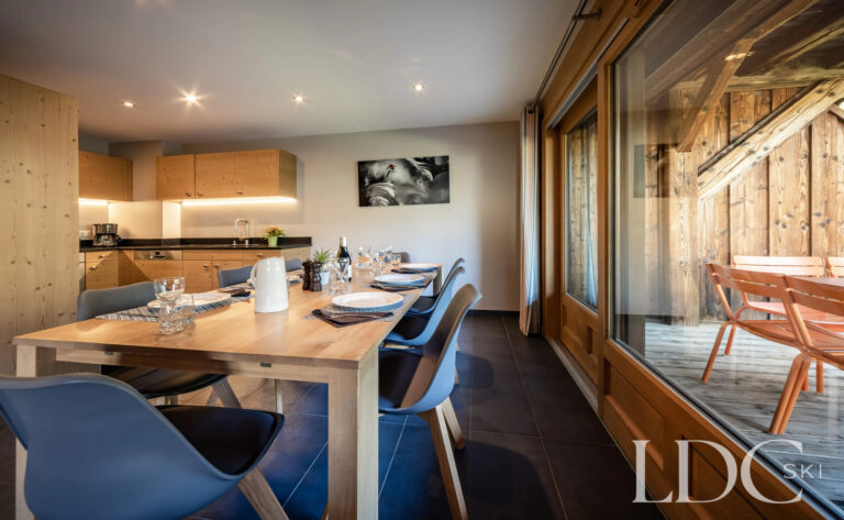 Dining area opening onto the balcony at Petit Sapin
