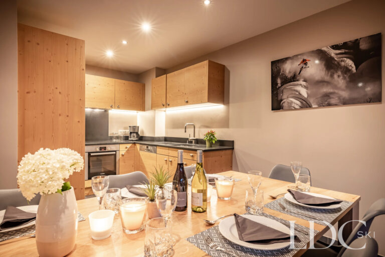 Kitchen and dining area set for dinner at Petit Sapin