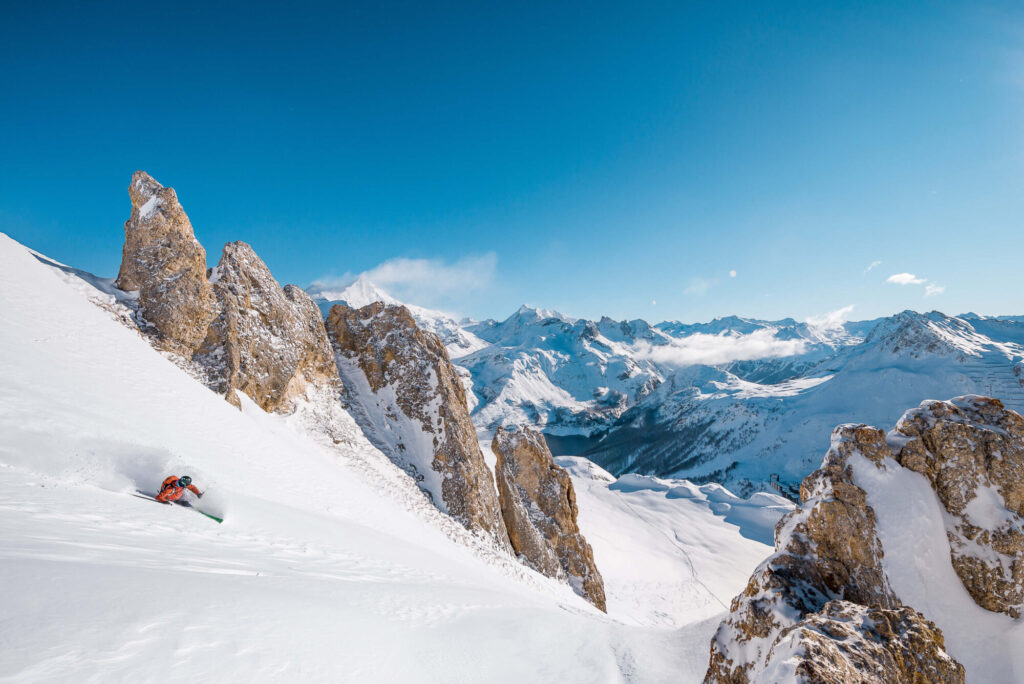 Skier descending through spectacular high-altitude scenery in Tignes. © Andy Parant