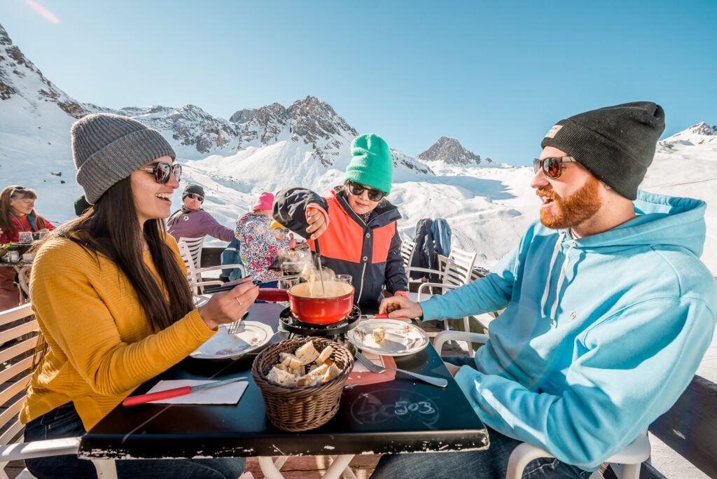 Skiers enjoying lunch outside in the sunshine in Tignes. © Andy Parant