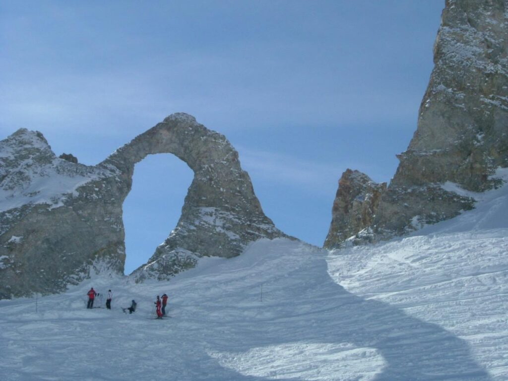 View of the distinctive Eye of the Needle rock formation in the mountains above Tignes