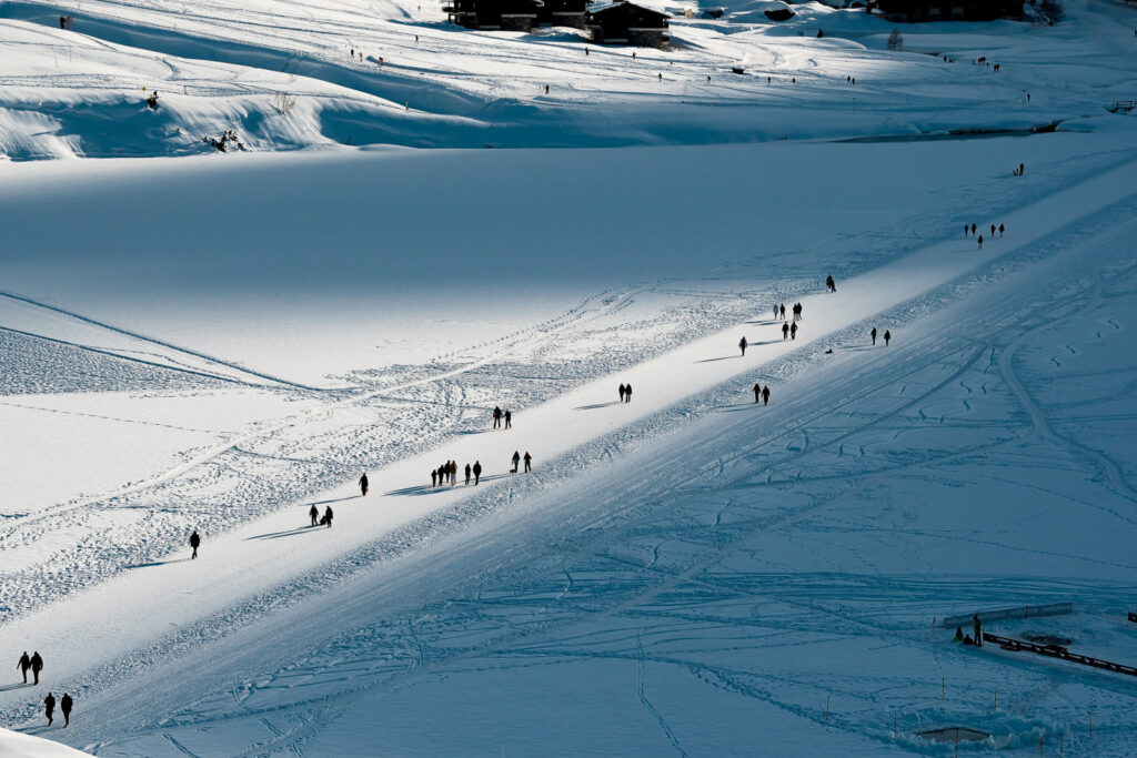 Skiers crossing the frozen lake in Tignes. © Andy Parant