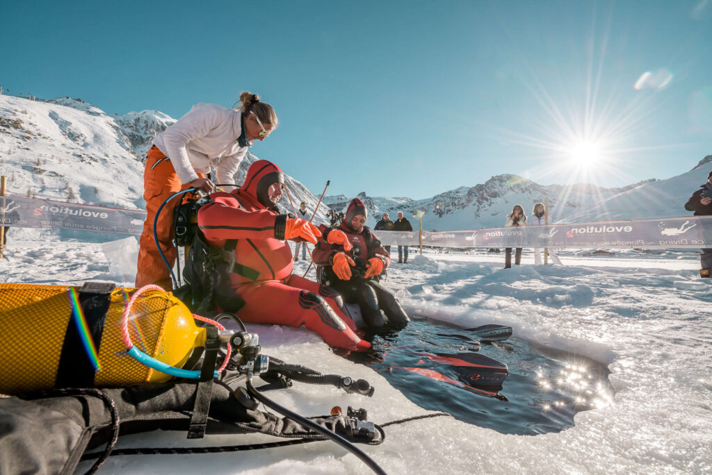 Visitors enjoying ice diving on the snow in Tignes. © Andy Parant