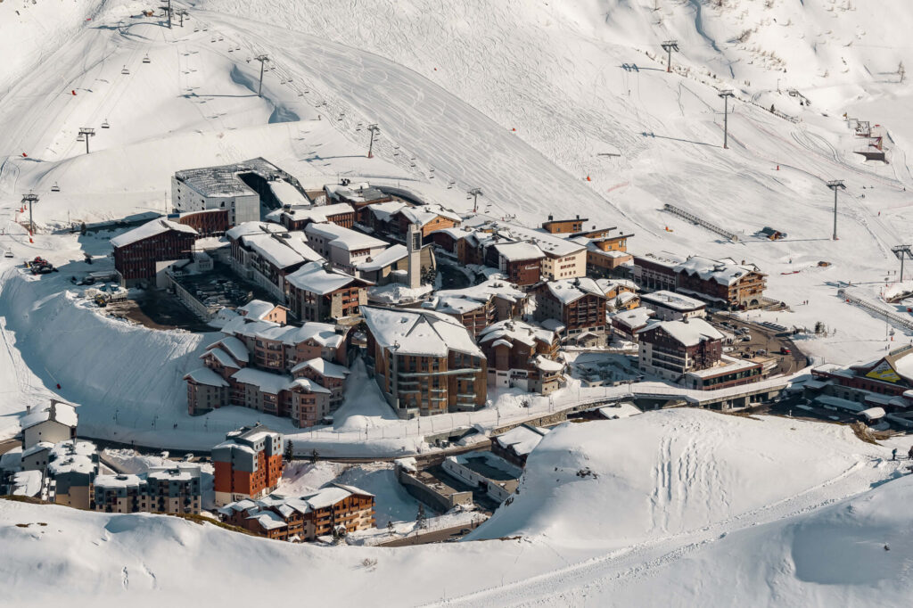 Aerial view of the snow-covered resort buildings and slopes in Tignes. © Andy Parant