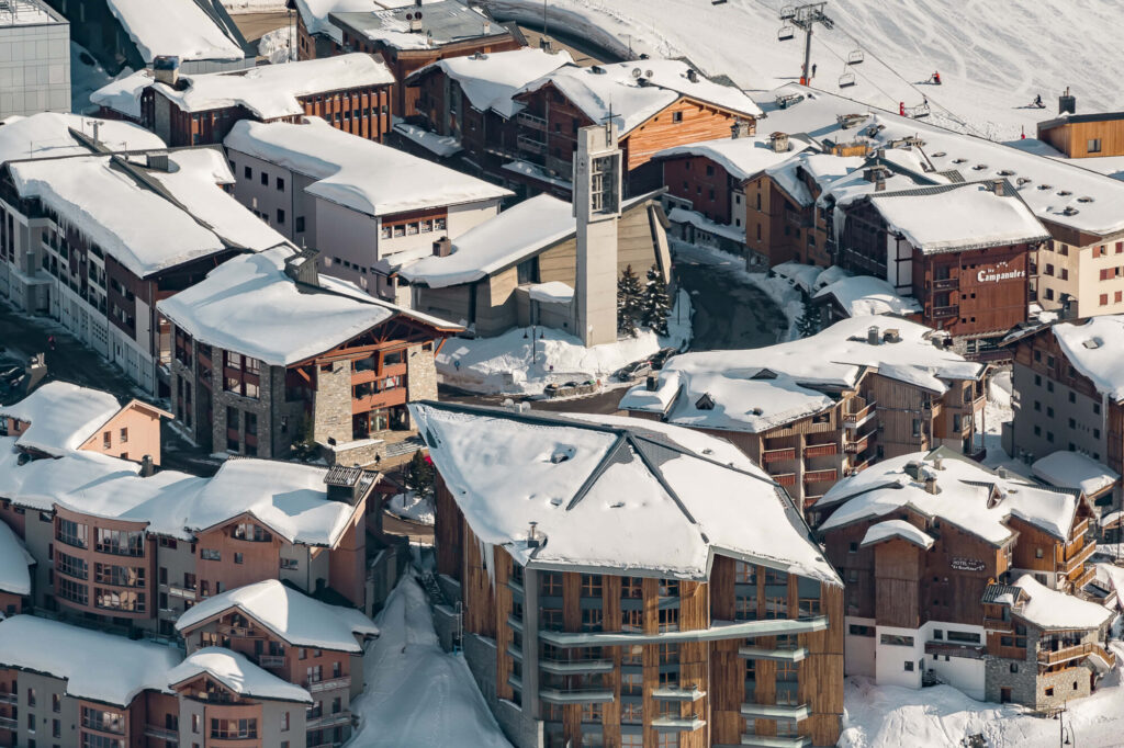 Close aerial view over the snow-covered buildings of Tignes. © Andy Parant