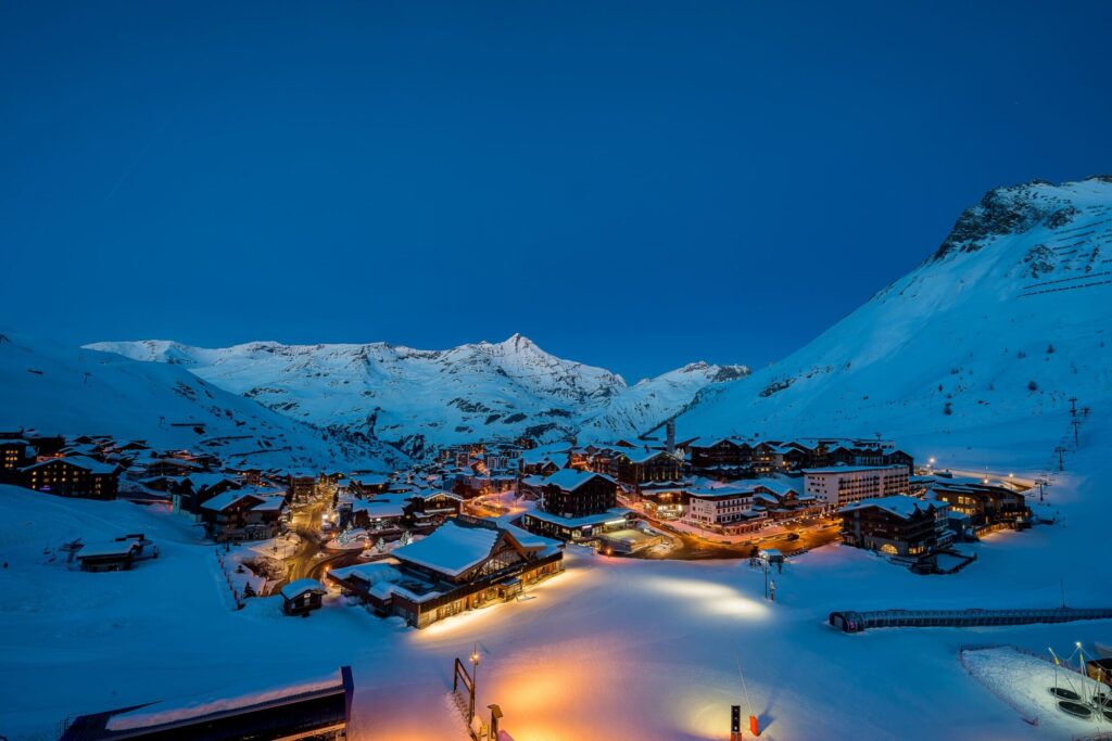 Tignes glowing beneath the mountains during a winter blue hour. © Andy Parant