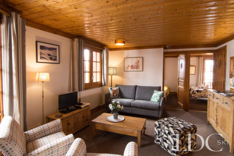 Comfortable lounge with large windows and traditional timber ceiling at Violette