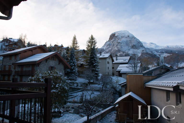 View across snowy chalets towards the mountains from Violette in St Martin de Belleville